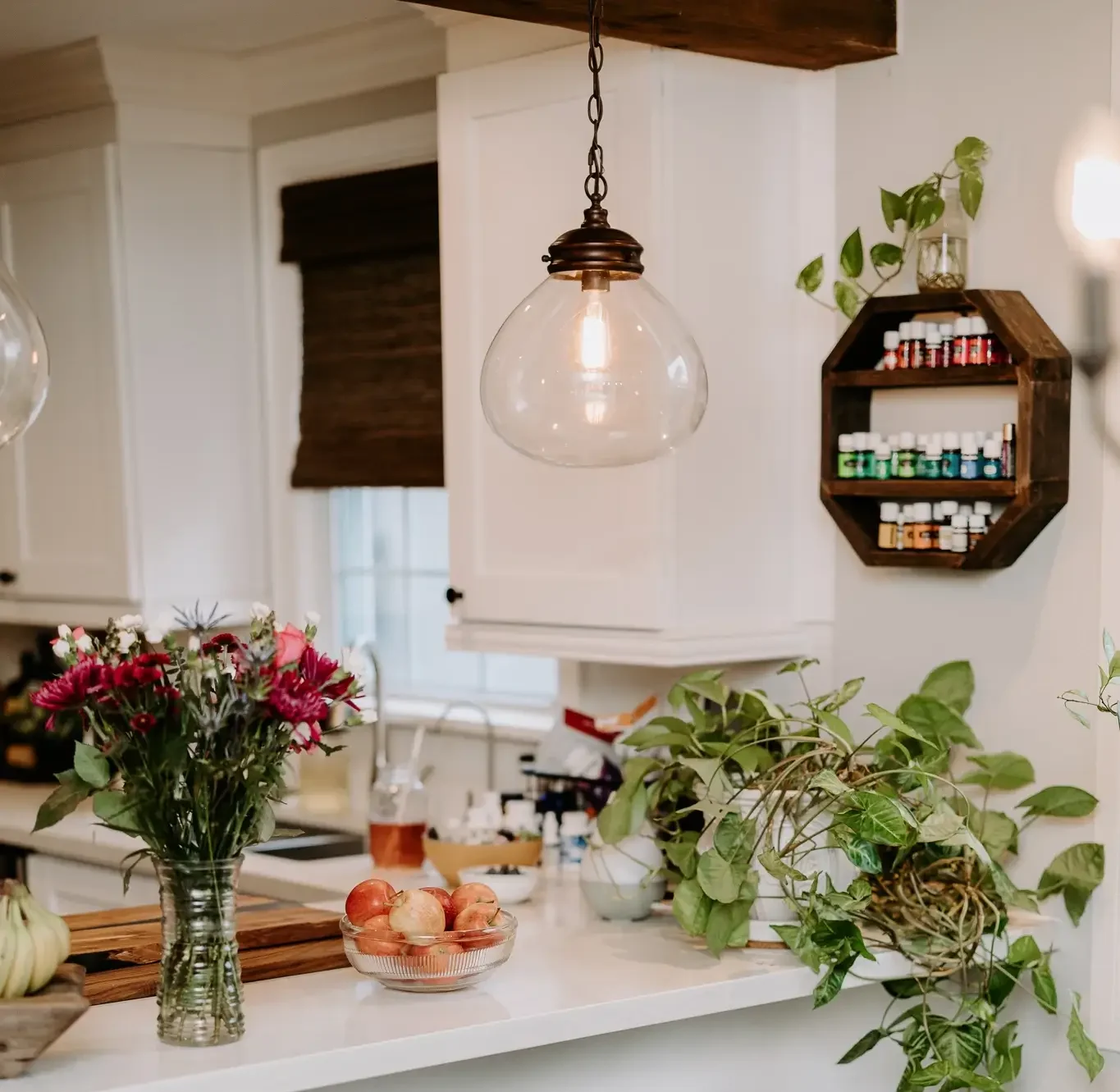 Kitchen with Young Living essential oils displayed on wooden shelf